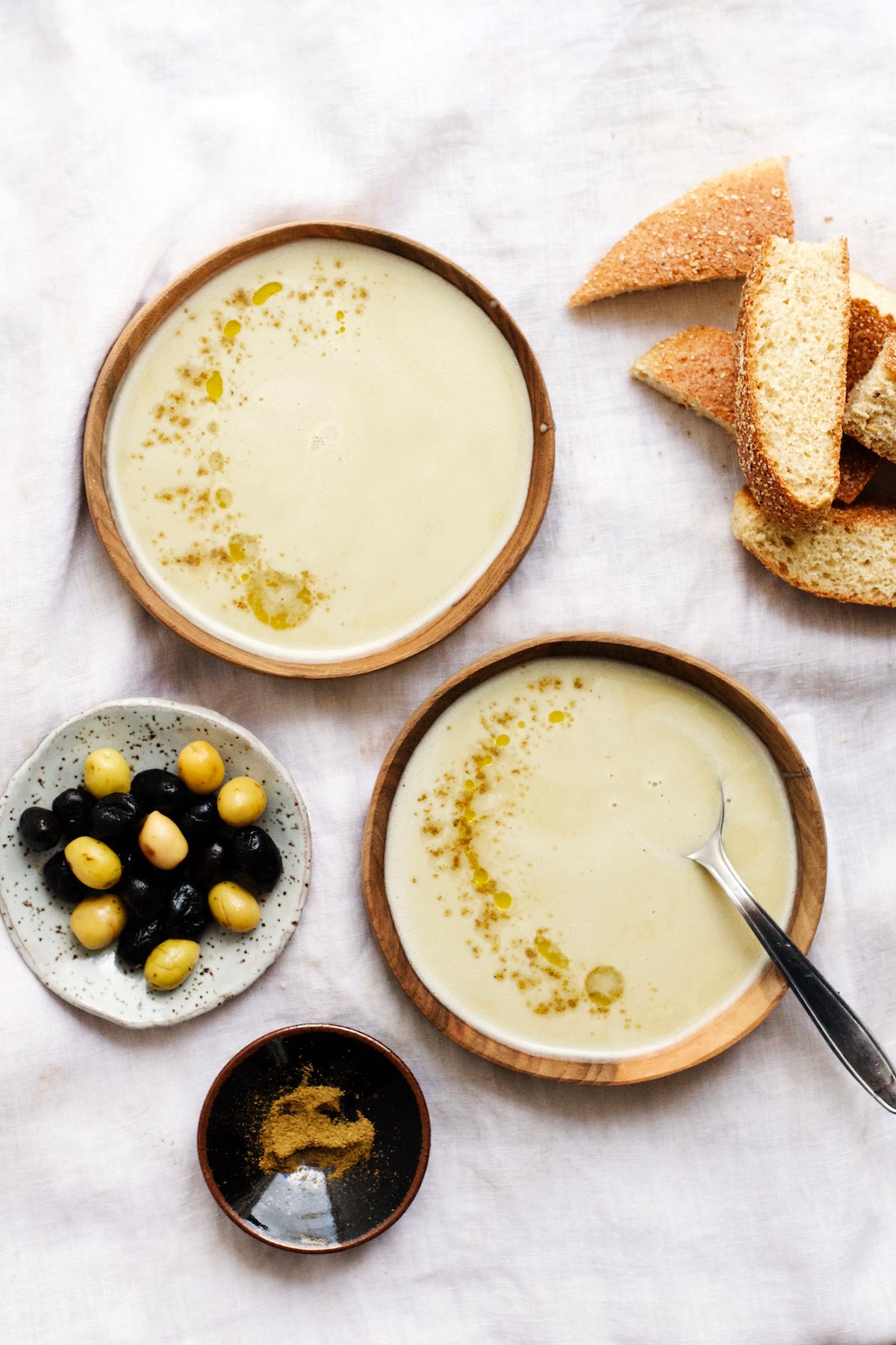 A bowl of bissara, thick Moroccan fava bean soup, with olive oil and bread