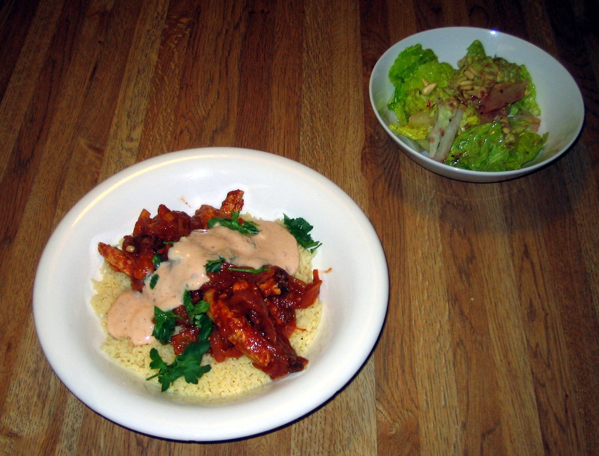 Chicken tagine with preserved lemon and olives served in a traditional clay dish