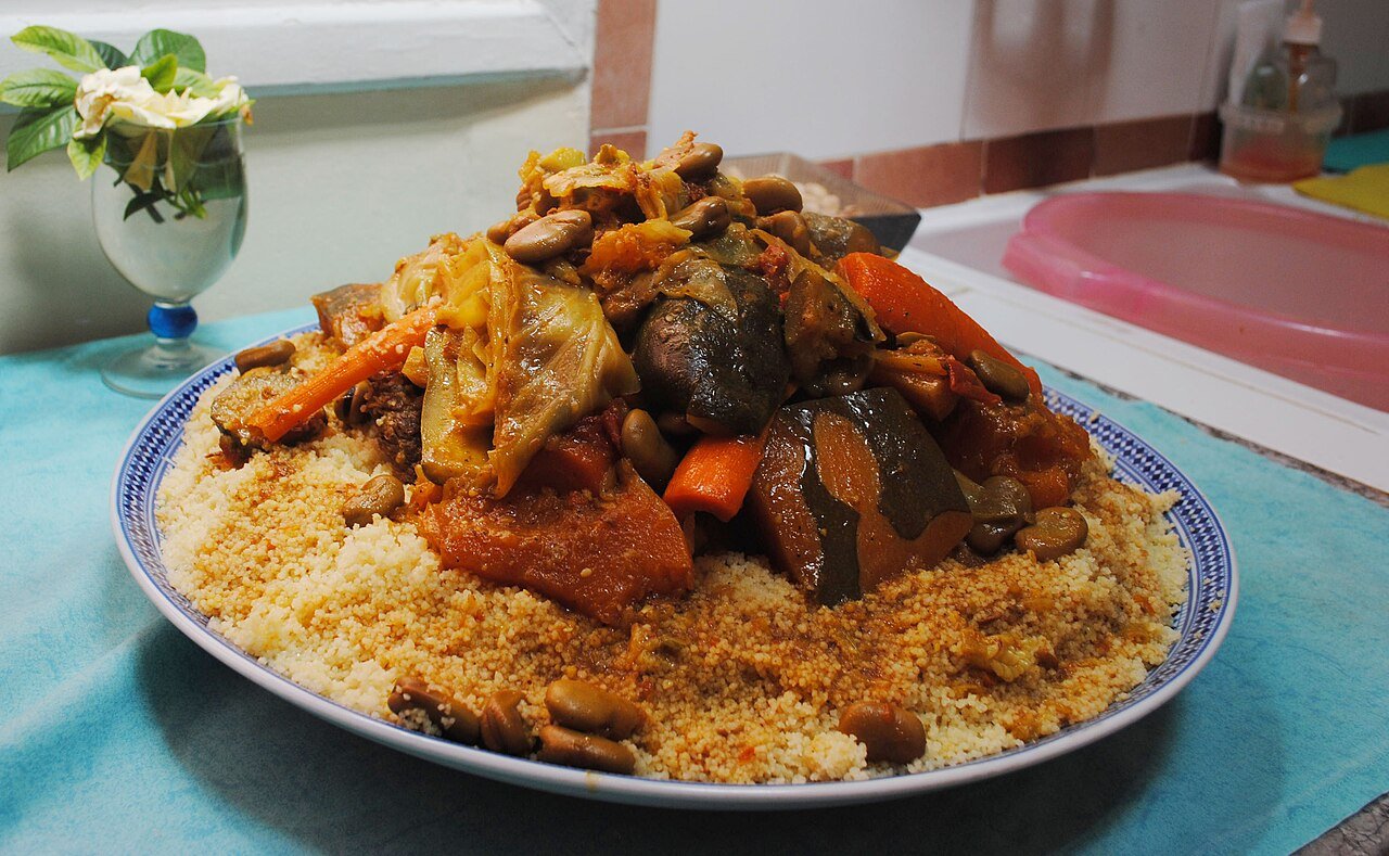 Moroccan couscous topped with seven stewed vegetables including carrots, pumpkin, cabbage and chickpeas