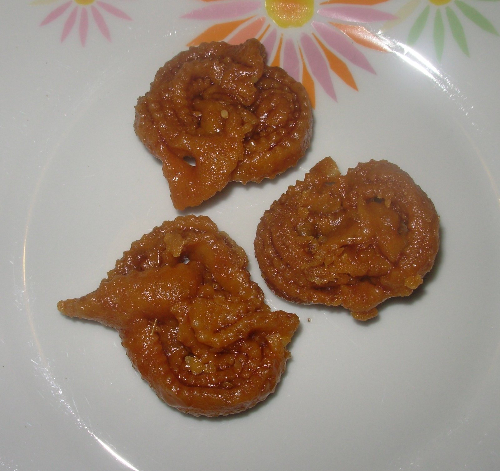 Chebakia cookies dipped in honey on a plate