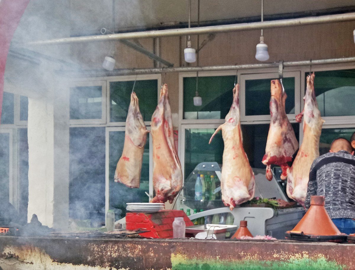 Butcher shop and grill counter with tagines cooking in Morocco
