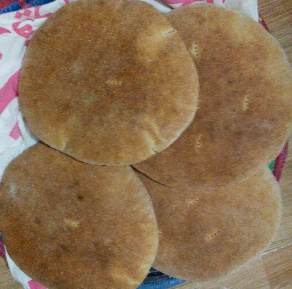 Round Moroccan khobz flatbread, served warm with mechoui