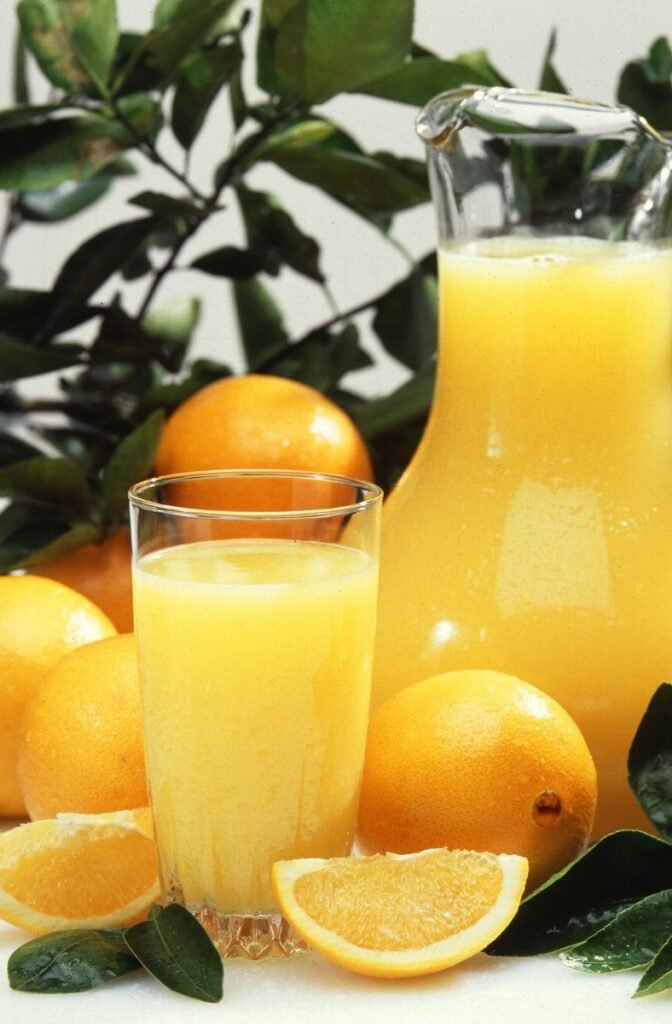 Fresh oranges and freshly squeezed orange juice