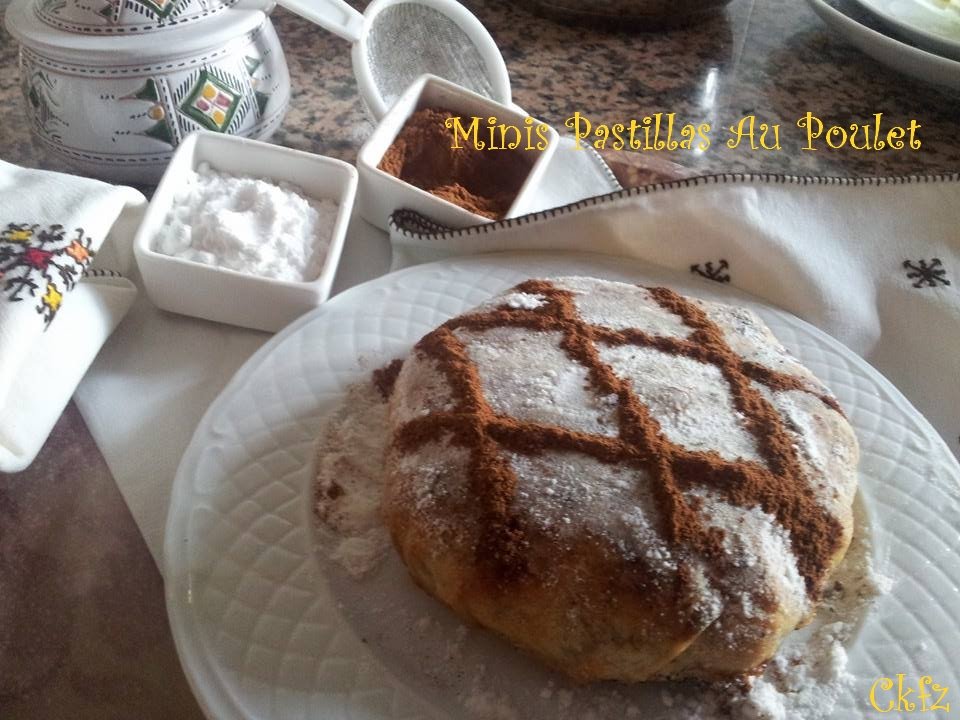 Individual chicken pastilla dusted with powdered sugar and a cinnamon lattice, served with small bowls of sugar and cinnamon