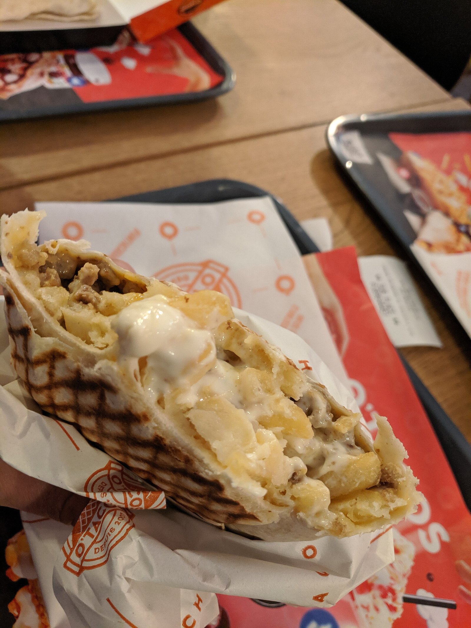French tacos with meat, fries and melted cheese, grilled in a press