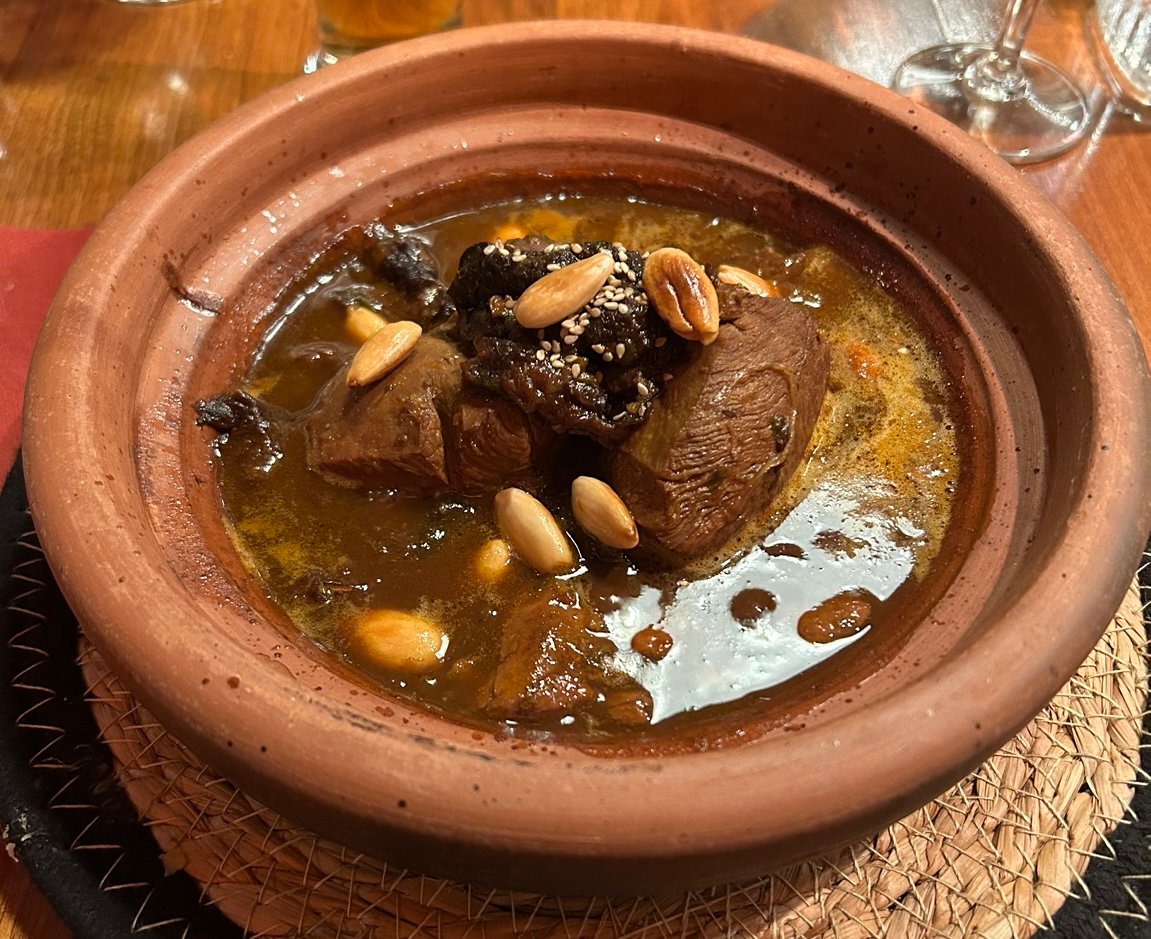 Lamb tagine with prunes and almonds served in a clay tagine dish