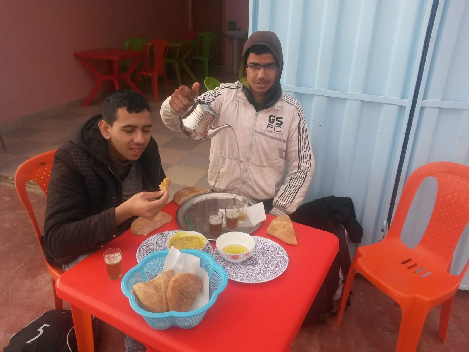 Two men drinking mint tea at a café in Morocco